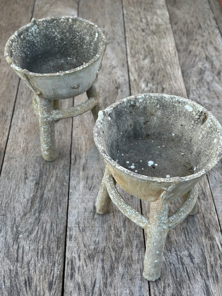 A pair of vintage 1950s French rustic planters with a patinated finish, displayed on a wooden surface.