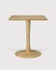 This image features the Lottie Oak Pedestal Table, a stylish and elegant piece suitable for any modern dining area. The table is crafted from solid oak and finished with a matte varnish, emphasizing its natural wood texture and color.